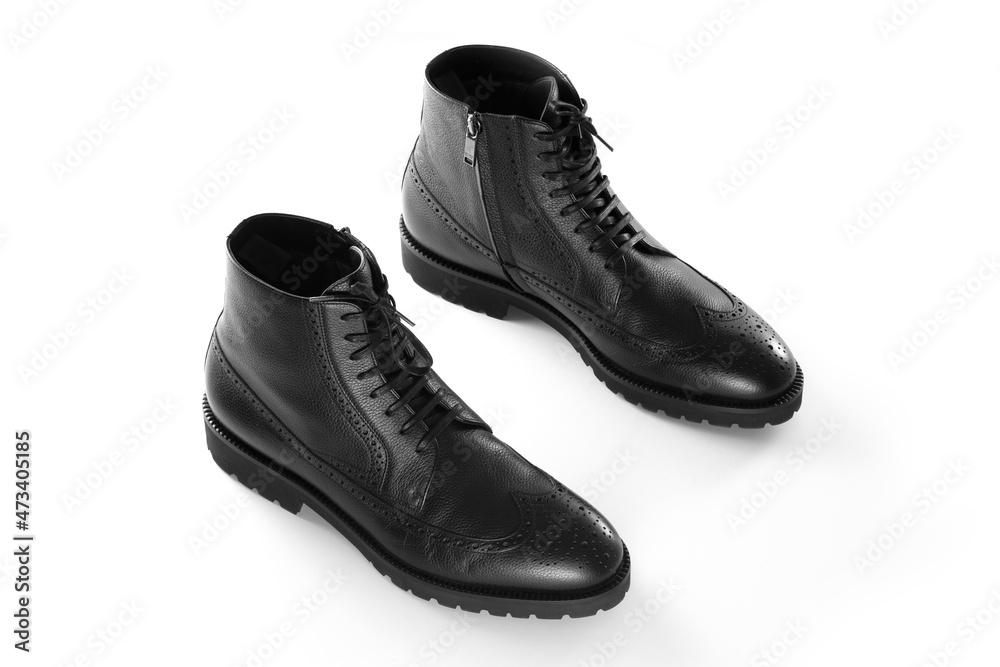 A pair of black leather men's boots, Full brogue, luxury men's shoes, fashion, casual boots, winter boots, white isolated background, product photography