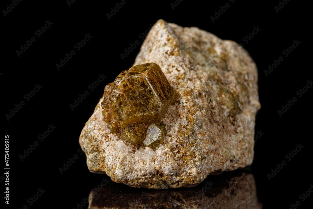 Macro stone Grossular mineral on a black background