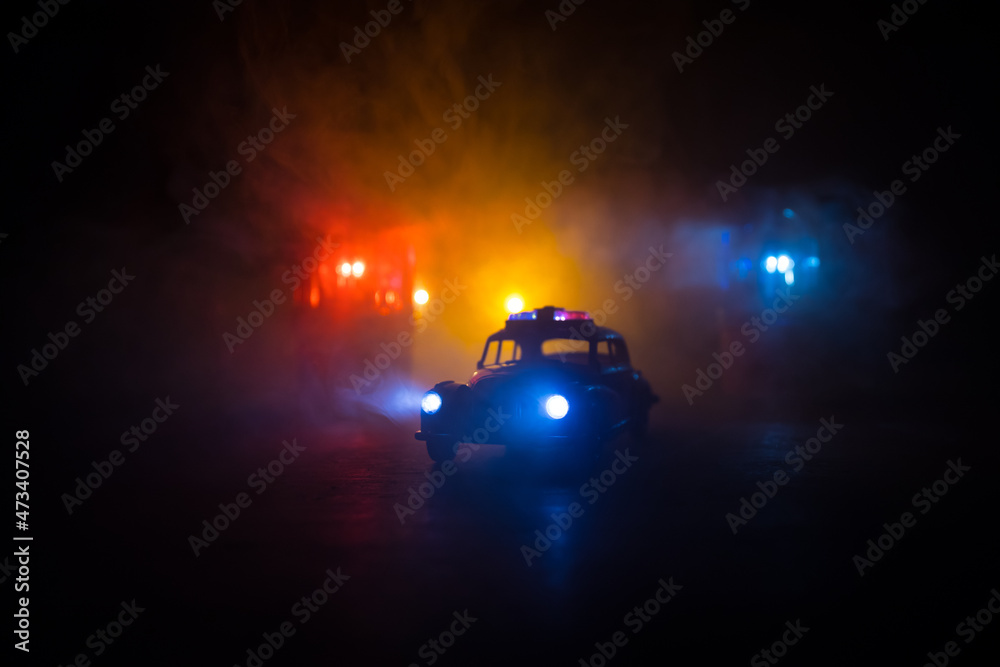 Police car chasing a car at night with fog background. 911 Emergency response police car speeding to scene of crime. Selective focus