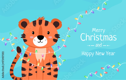 Baby tiger cub and New Year's garland. Cute tiger, symbol of the year on a blue winter background. Christmas banner with lanterns, New Year greetings. The animal is drawn in flat style.