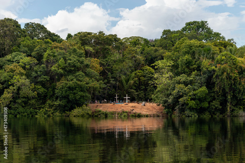 Small cemetery on the banks of a river in a traditional community in the interior of the Amazon region in Brazil photo