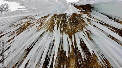 Close up of icicle at icefall Rotes Tor, Rankweil, Vorarlberg. Low angle view. photo