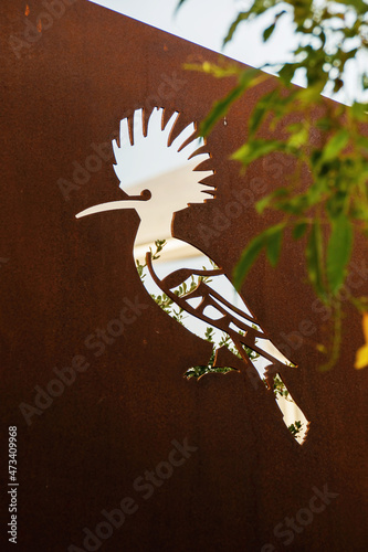 Corten wall with carved bird detail