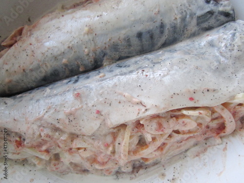 fish stuffed with vegetables and sauce prepared for baking