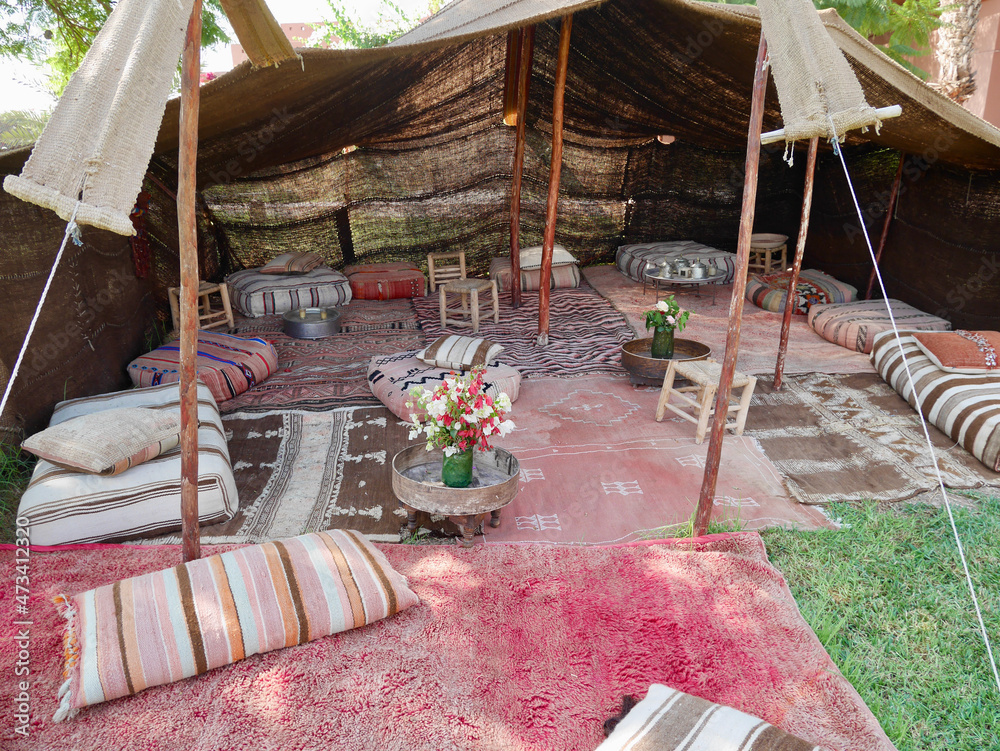 Bedouin tent with cozy pillows and colorful carpets in Marrakech, Morocco.  Photos | Adobe Stock