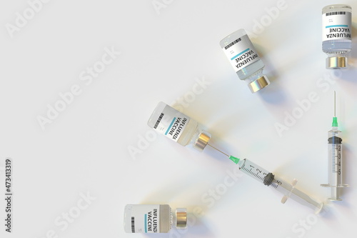 Clock face made with influenza vaccine vials and syringes. Vaccination time concept. Conceptual medical 3D rendering
