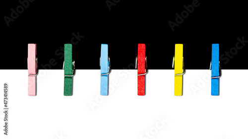 Colorful clothes pins and paper sheets background