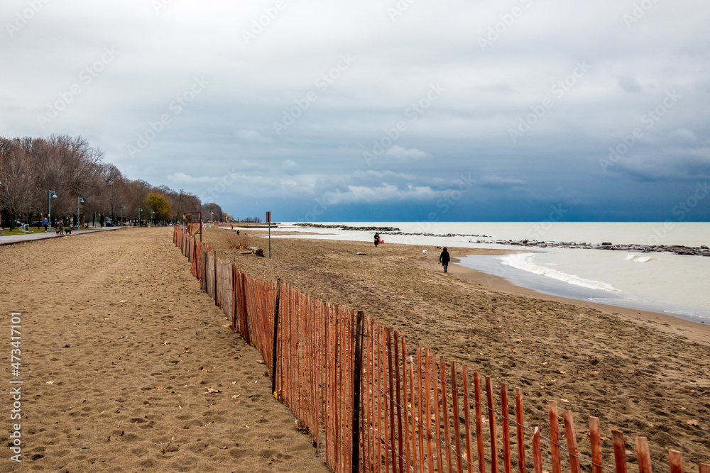 Snow fences mark the off leash areas for dog walkers in a public park along the shore of Lake Ontario. Shot in Toronto’s iconic Beaches neighbourhood in December.