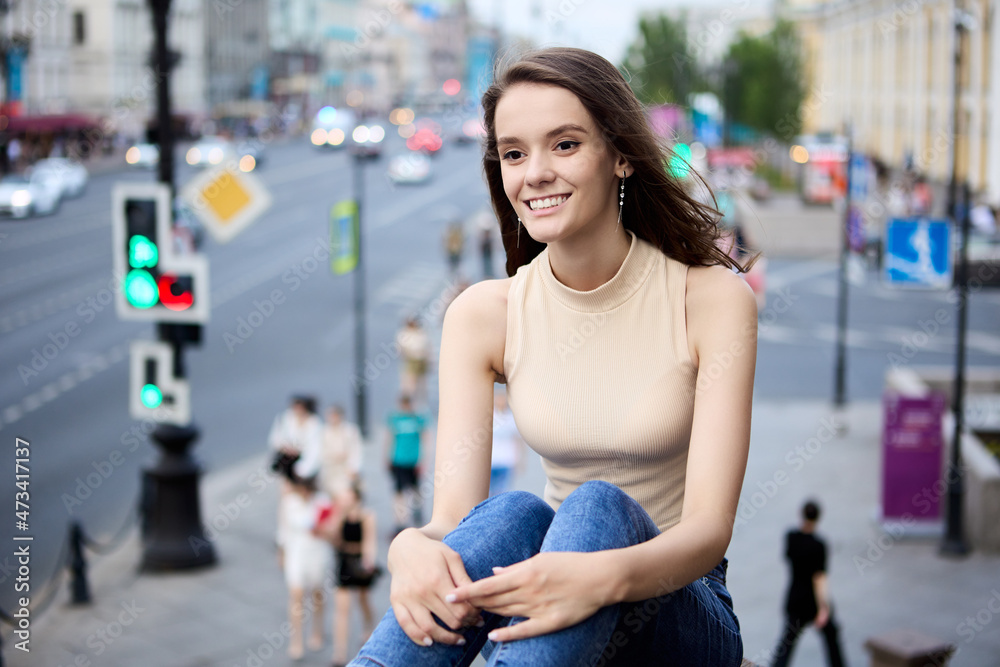 An 18 year old woman on crowded city street with heavy traffic. An 18 year old woman on crowded city street with heavy traffic.