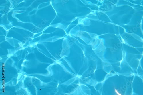 Blue ripped water in swimming pool . texture pool Shining blue water ripple background © sleepkill