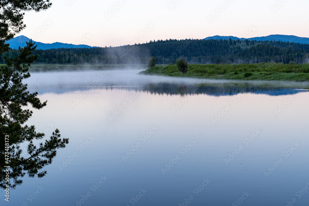 Early morning foggy steam sunrise on the Snake River at Oxbow Bend in Grand Teton National Park Early morning foggy steam sunrise on the Snake River at Oxbow Bend in Grand Teton National Park