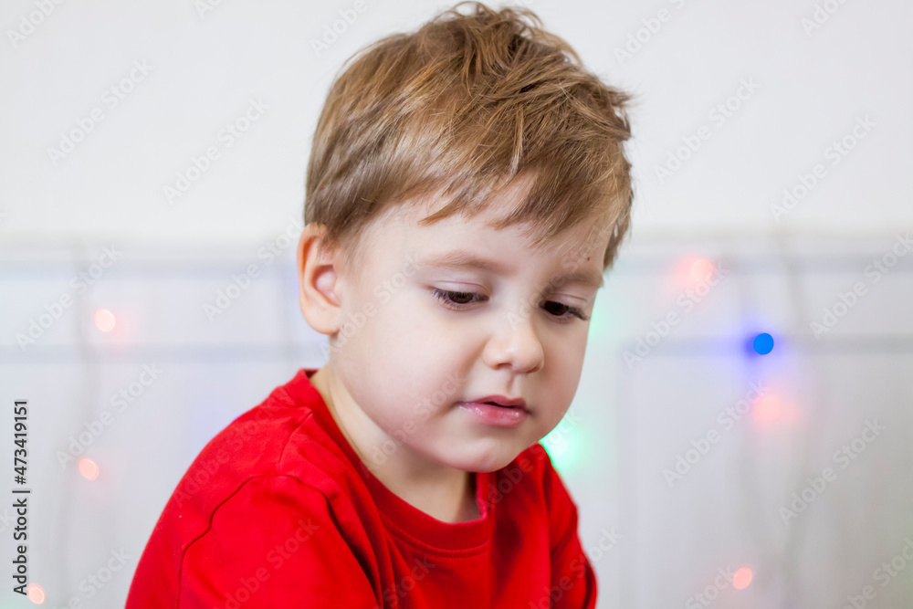 Portrait of a child in a red jacket in a bright room. Emotional child, joy, Portrait of a child in a red jacket in a bright room. Emotional child, joy,