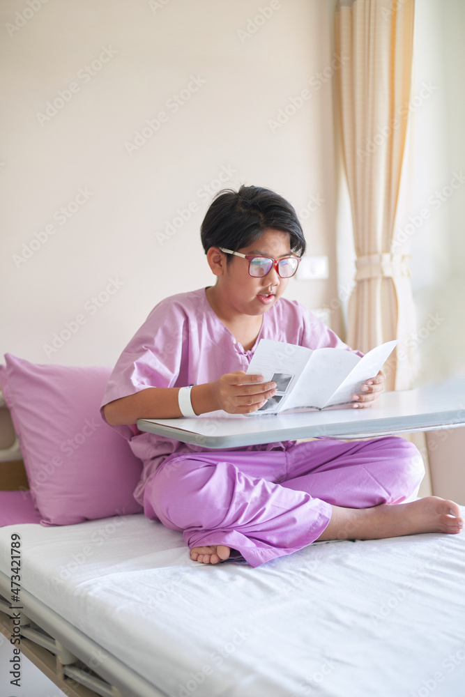 The boy patient was resting by reading health pamphlets