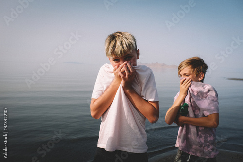 Boys Cover their Noses to avoid the Sulphur Smell at Great Salt Lake. photo