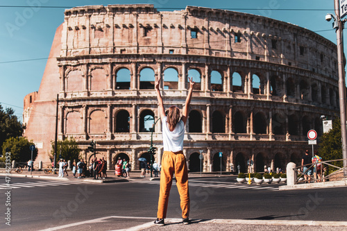 Happy woman in front of the Roman Coliseum