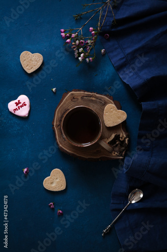 Tea cup with cookies and flowers photo