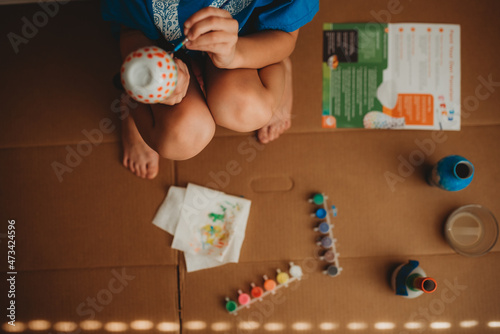 Child painting with paint kit photo
