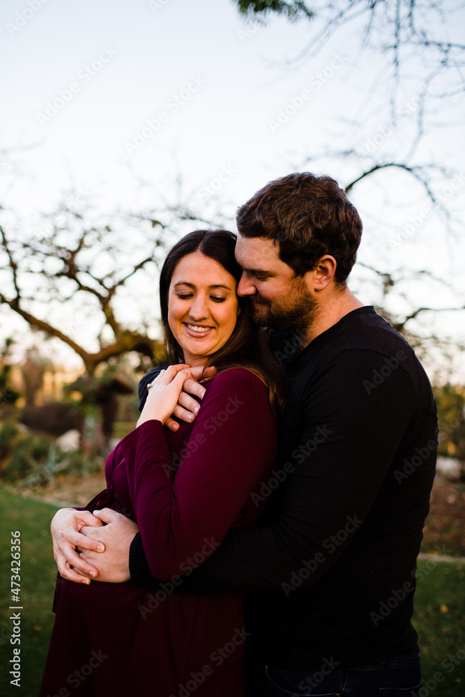 Expectant Couple Embracing at Park During Sunset in San Diego