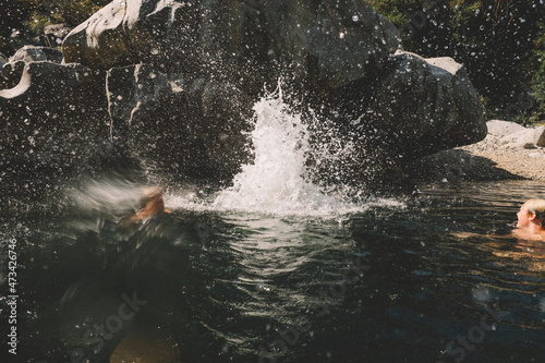 Big Splash and Water Spray from Boys Jumping into a Swimhole photo