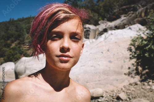 Boy With Pink Hair and Long Eyelashes looks at camera photo