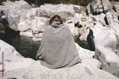 Figure Cloaked in a towel Looks like the surrounding Rock. photo