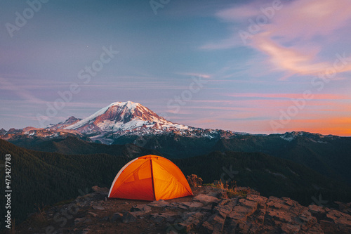 Orange tent on the top of the mountain near mt. Rainier