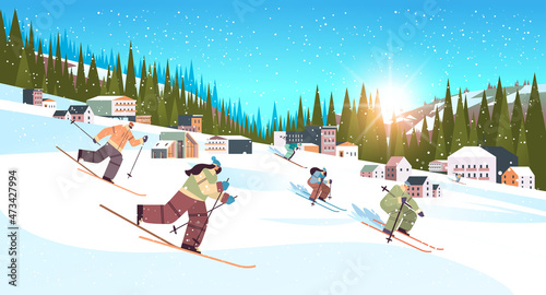 people skiing men women tourists doing activities winter vacation concept snowfall landscape background
