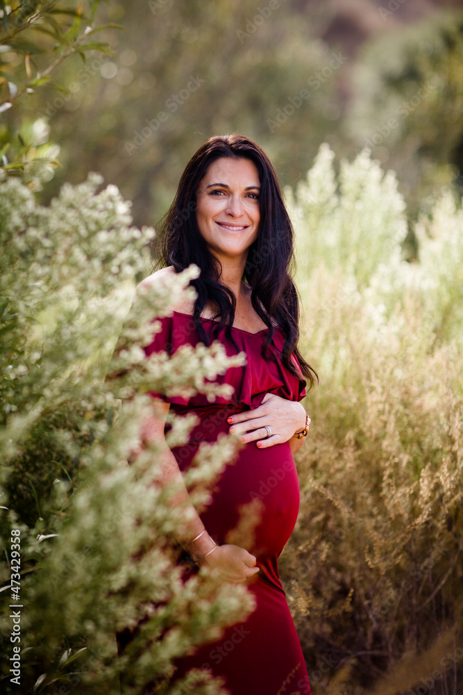 Expectant Mother Standing in Field Smiling for Camera in San Diego Expectant Mother Standing in Field Smiling for Camera in San Diego