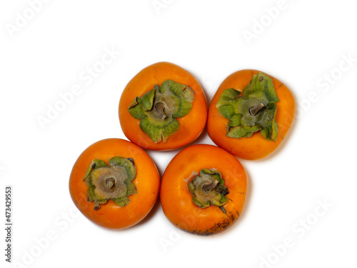 persimmon chamomile on white background. Healthy diet. Fruit on the table.