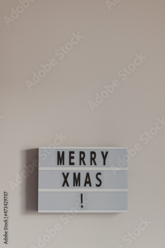 vertical merry christmas written on a box letter
