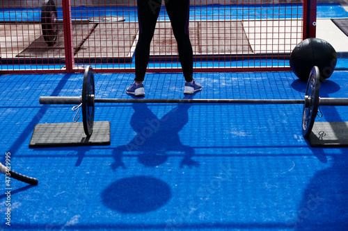Shadow of female exercising with medicine ball photo