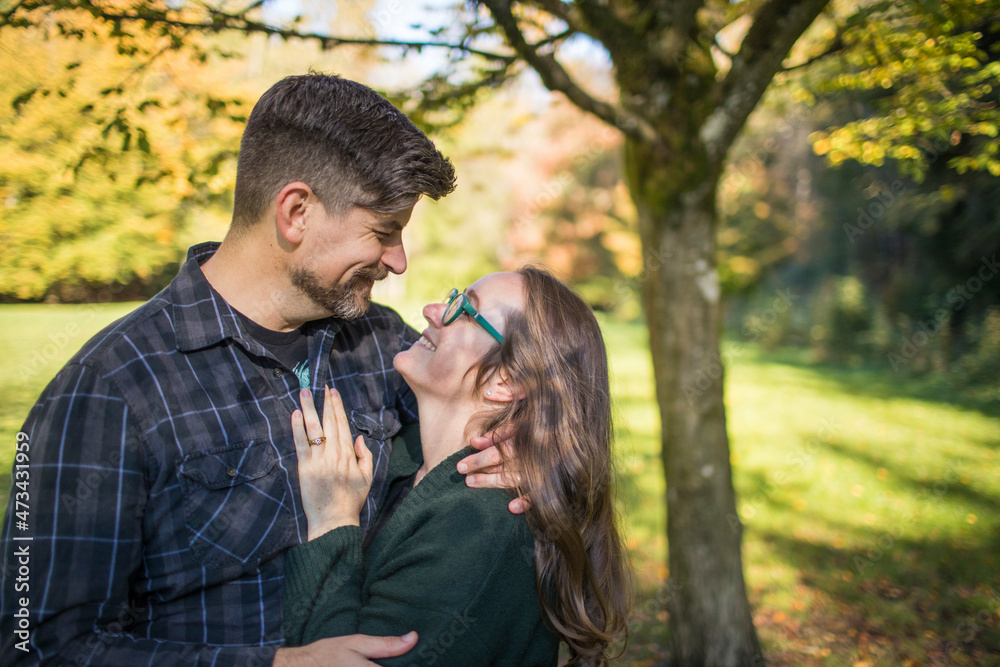 Millennial aged couple embrace, look into each others eyes. Millennial aged couple embrace, look into each others eyes.
