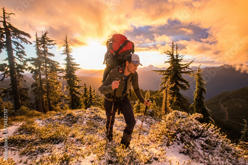 Backpacker hiking on mountain summit, Whistler, B.C. photo