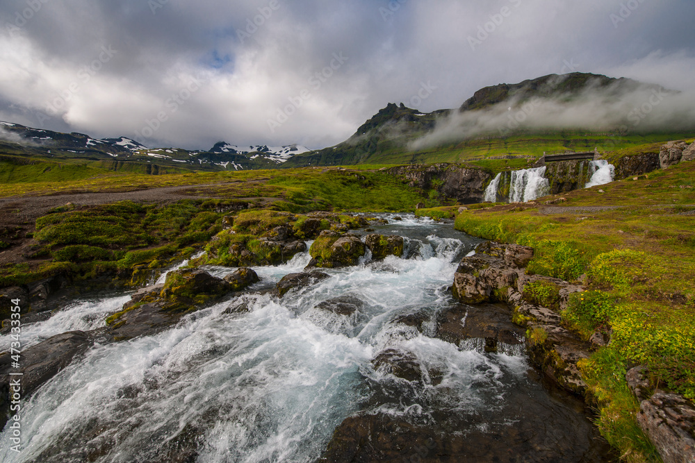 the famous waterfall Kirkjufellsfoss in West Iceland the famous waterfall Kirkjufellsfoss in West Iceland