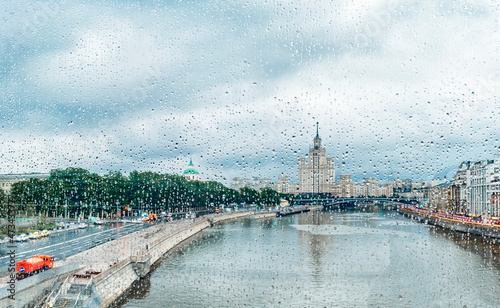 View through glass with raindrops of The Moskva River, Kotelnicheskaya Embankment Building in Moscow, Russia