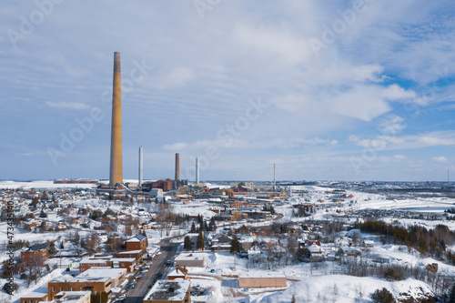 Smoke Stack Rises 1000 Ft. Over Wintery Town photo