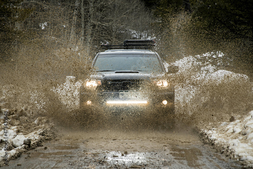 Truck driving through mud in spring photo