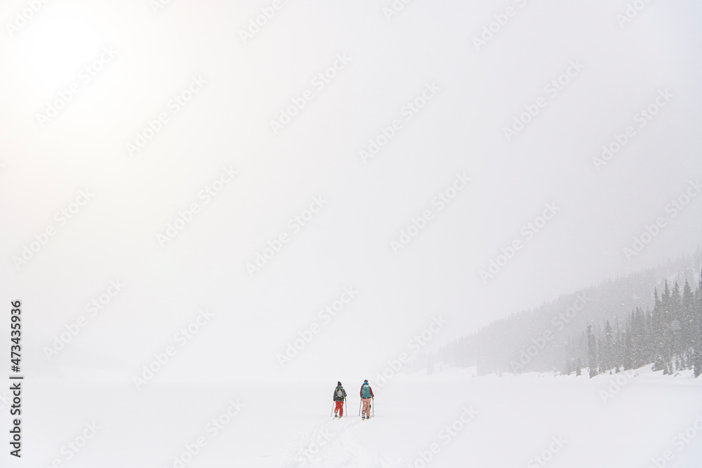 People splitboarding on snow covered landscape People splitboarding on snow covered landscape