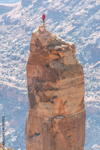 Man on rock pinnacle at Canyonlands National Park