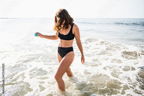 Woman Enjoying Morning Coffee before Surf photo