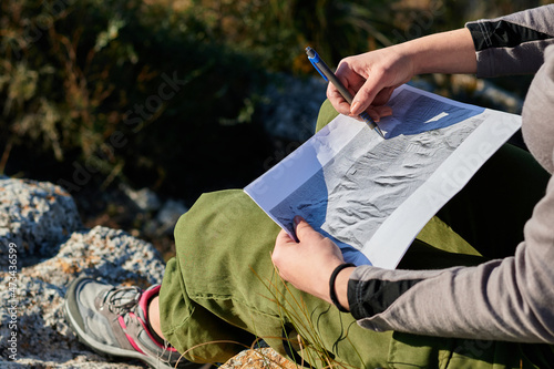 Close-up of a woman explorer and geographer analyzes the environment photo