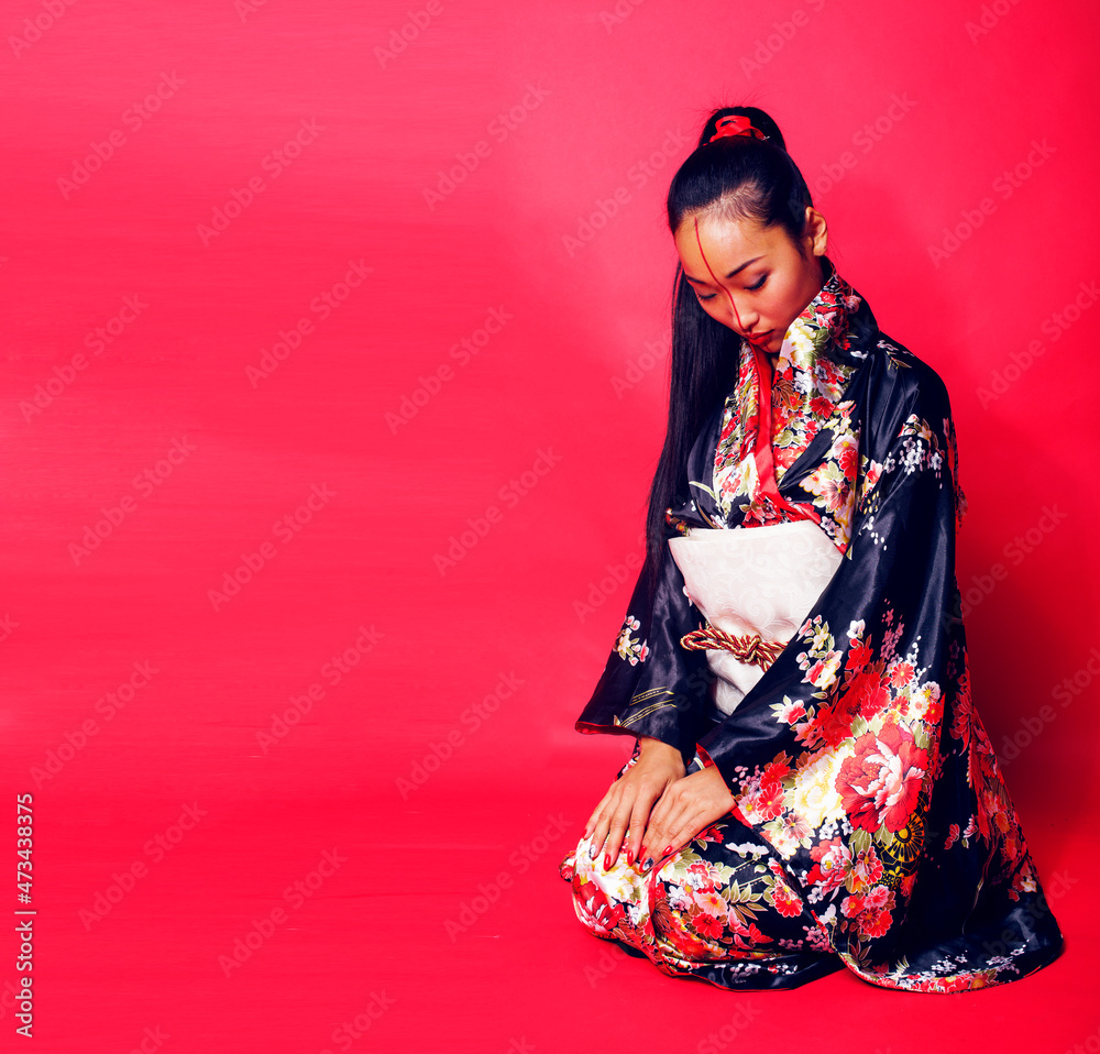 young pretty geisha on red background posing in kimono, oriental young pretty geisha on red background posing in kimono, oriental