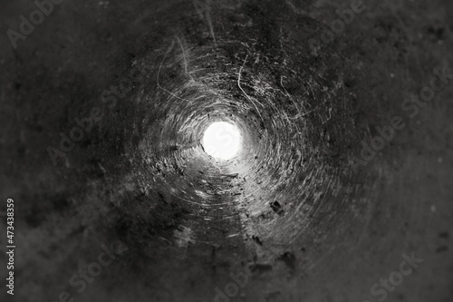 Deep dirty well tube view photo