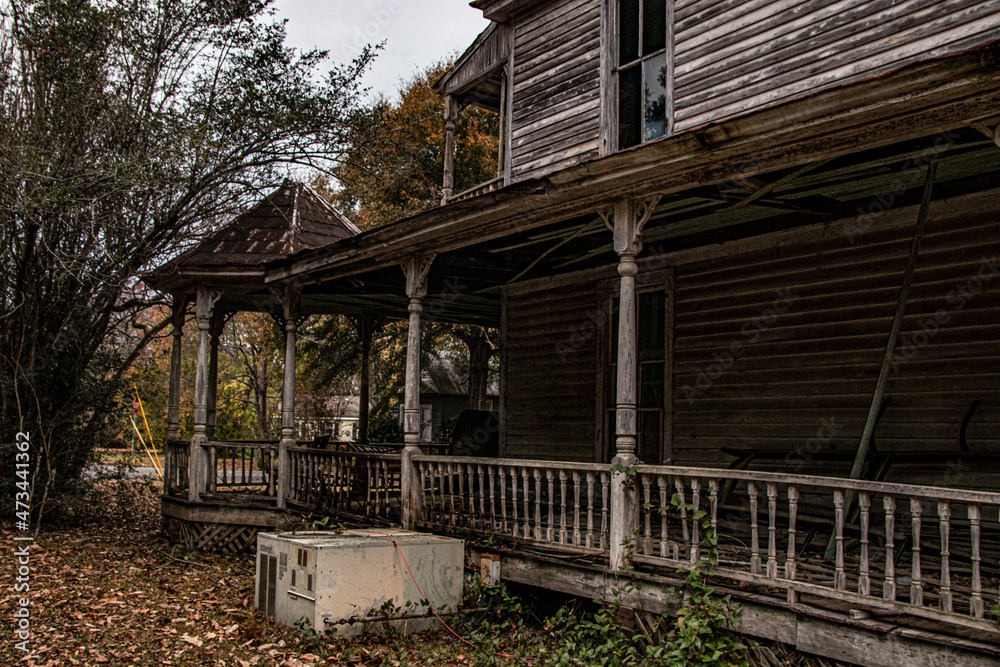 Abandoned dilapidated creepy wooden house side porch