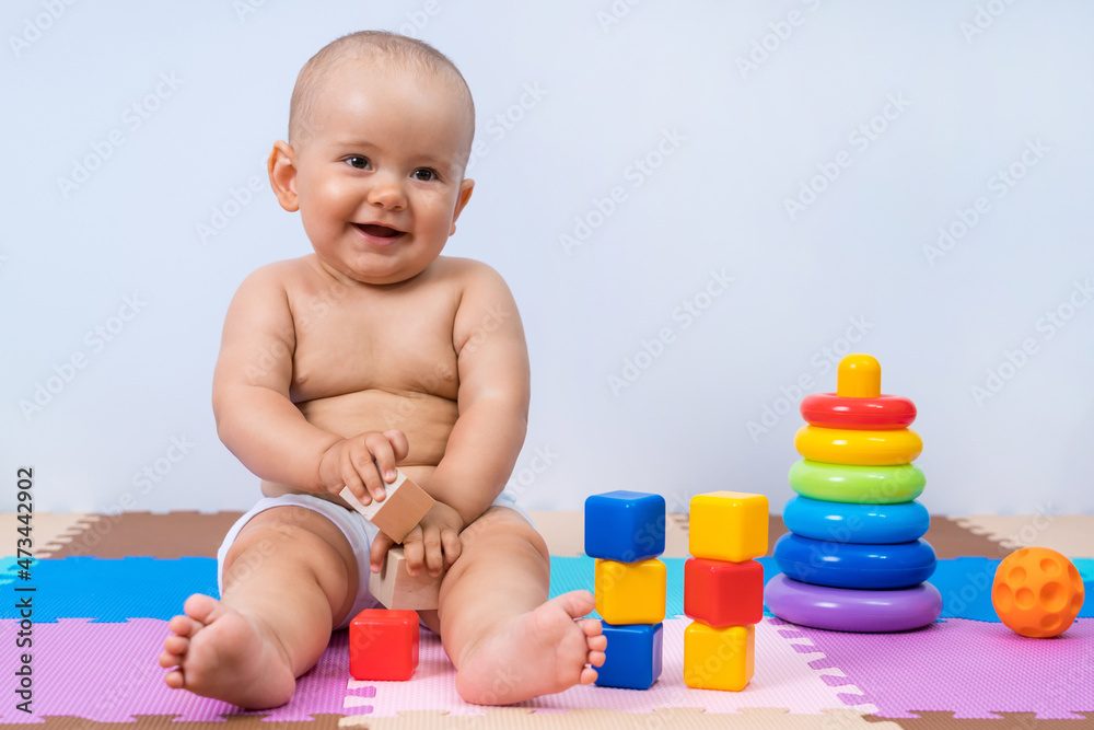Portrait of happy smiling baby 8-12 months old in playroom Portrait of happy smiling baby 8-12 months old in playroom