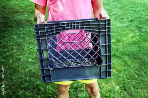 Teen boy holding a milk crate for the social media milk crate challenge photo