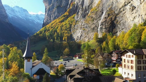 Revealing drone shot of the Staubbach waterfall church in Lauterbrunnen Bernese Oberland Switzerland photo