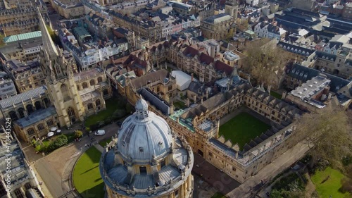 University of Oxford, sweeping aerial reveal passing the Church of Saint Mary the Virgin and the Radcliffe Camera Library.  photo