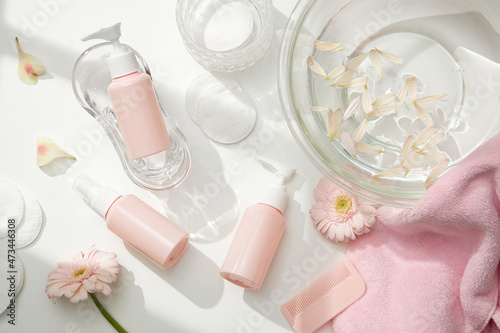 Top view of cosmetic jar in white bathroom with glassware and flower for cosmetic advertising , lifestyle content