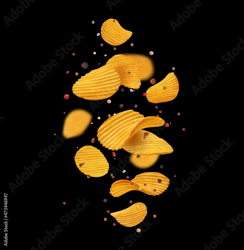 Falling crispy ripple potato chips, spices and herbs on black background. Realistic vector wavy slices of fried crisps, crunchy snack or junk food yellow chips flying with salt and pepper